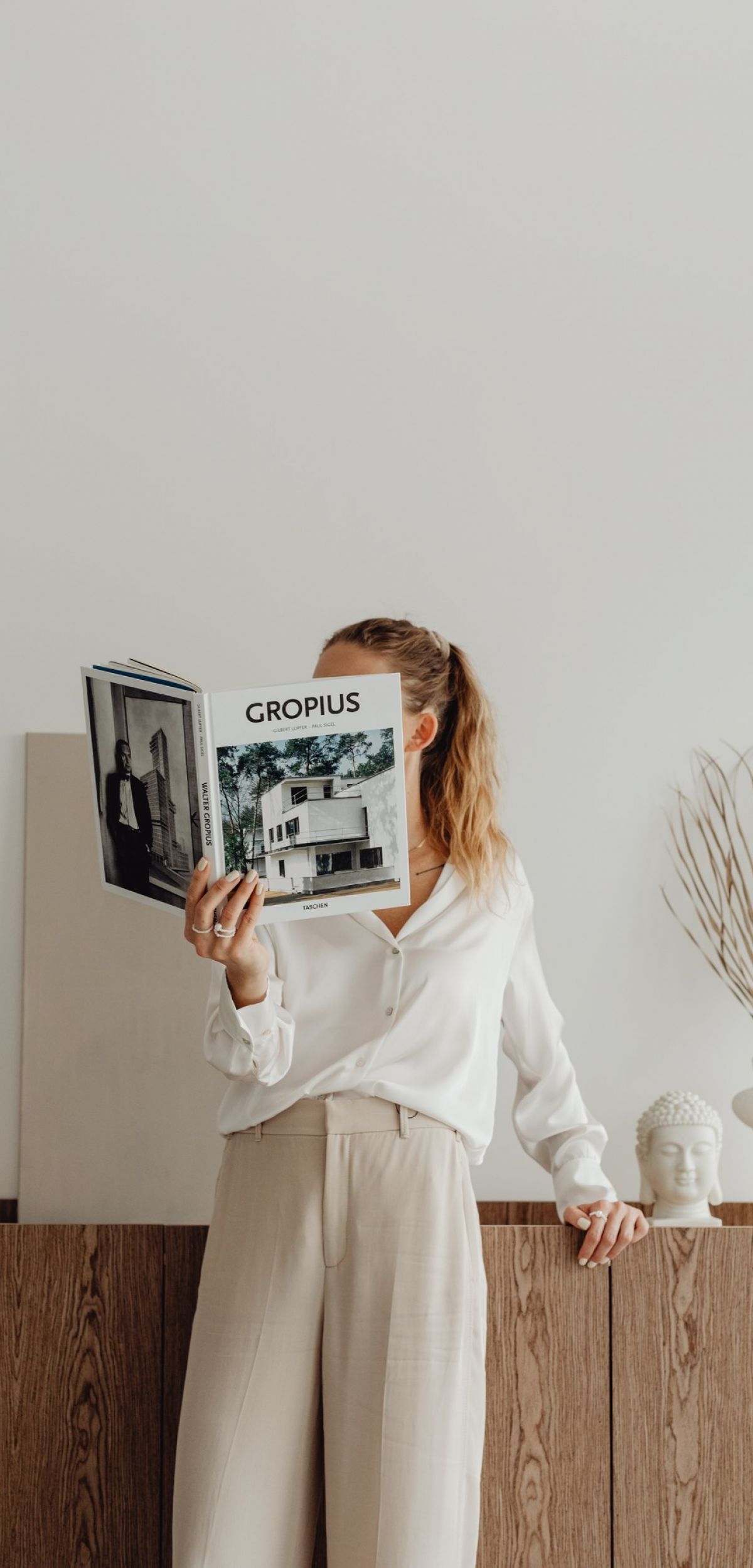 Woman reading a magazine while standing